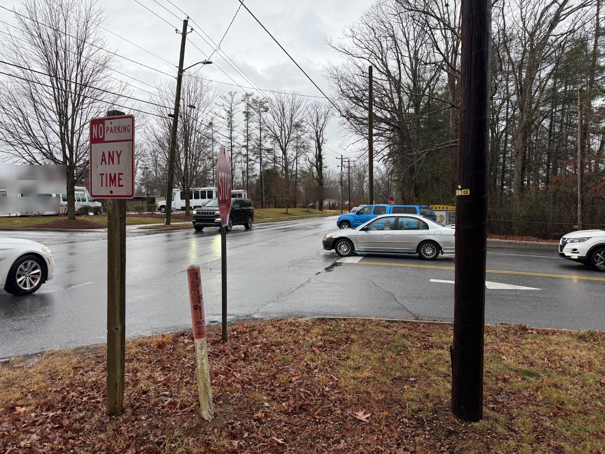 No Parking Any Time sign with school traffic behind it