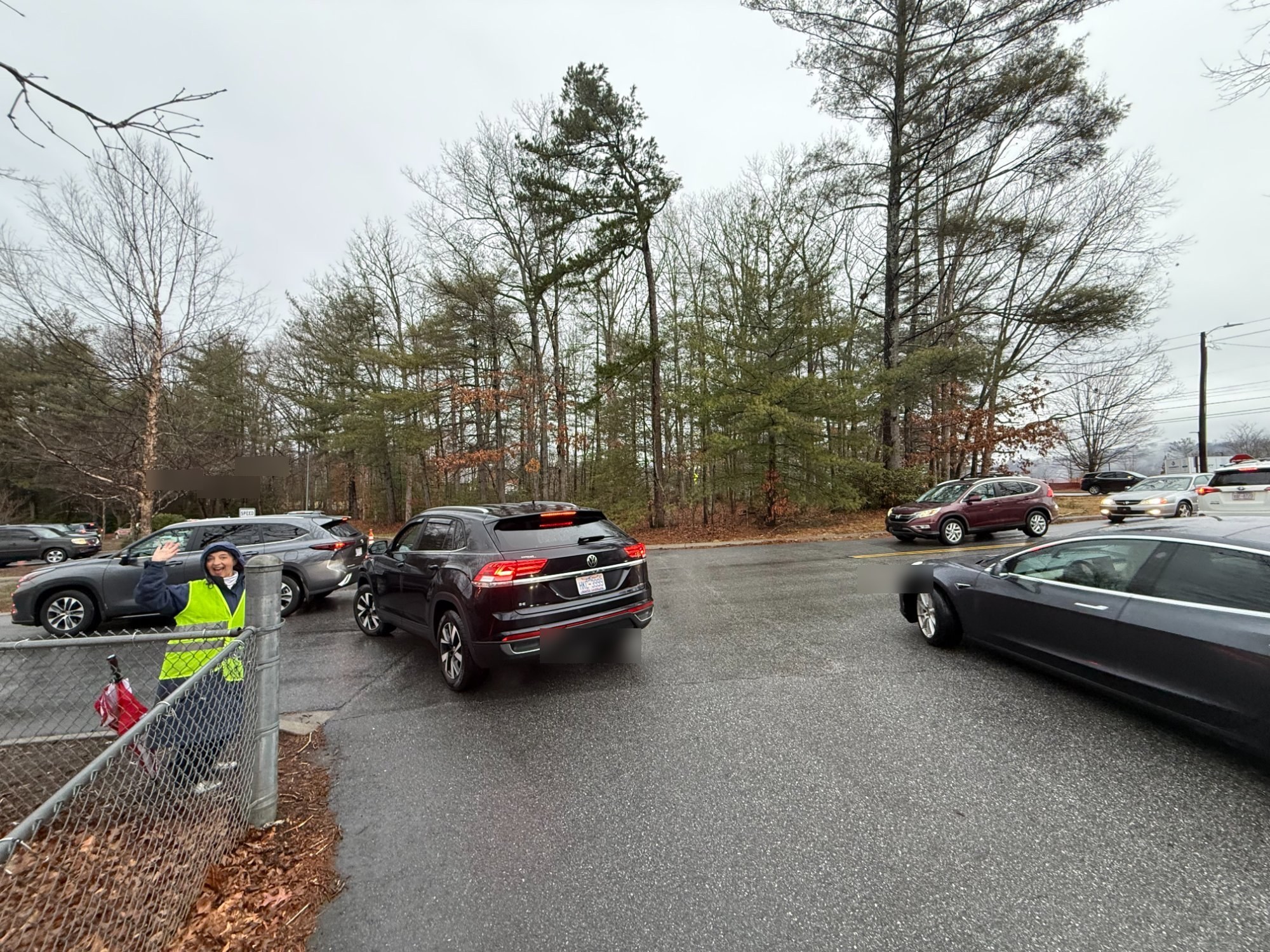 Dr. Pinkerton directing traffic in the rain